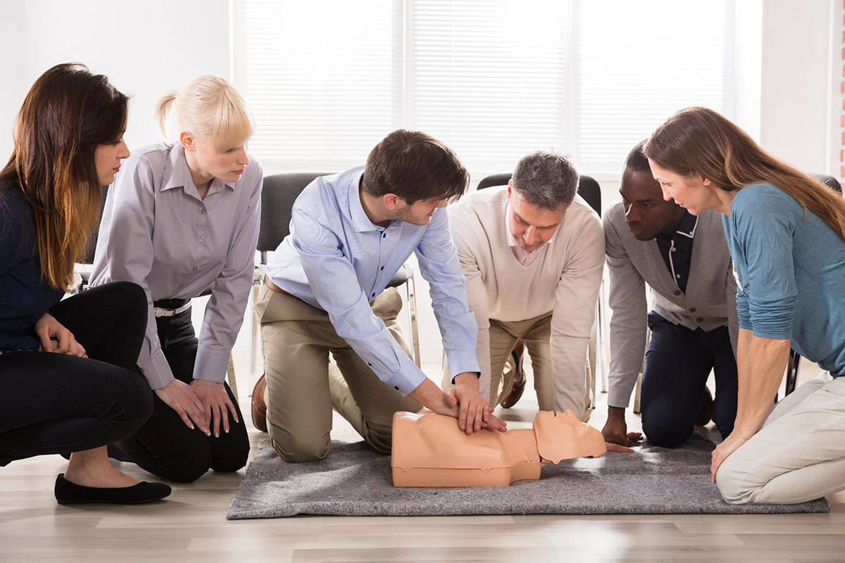 CPR Instructor Performing CPR on Dummy