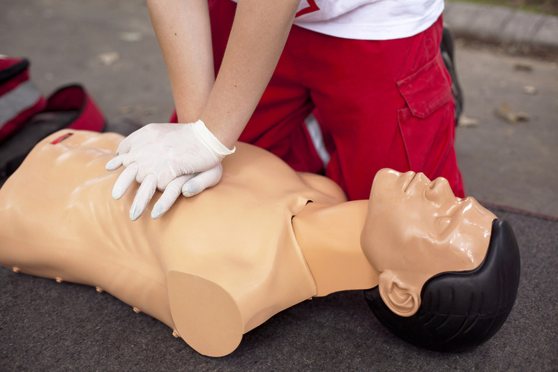 Instructor teaching CPR on Mannequin